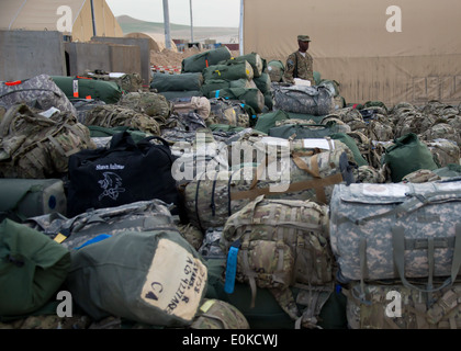 A soldier with the 1st Air Cavalry Brigade, 1st Cavalry Division, stands amid a sea of duffle bags and ruck sacks here, May 14. Stock Photo