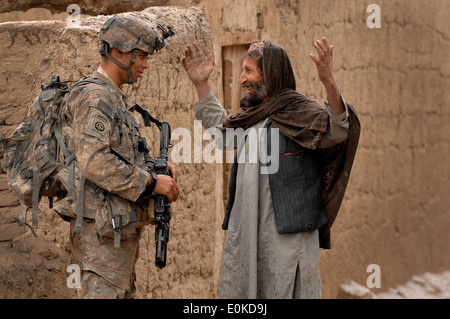 Private First Class Michael Elliott, Charlie Company 2508 Task Force Furry, talks with Mohammad Dode, a village resident, Feb. Stock Photo