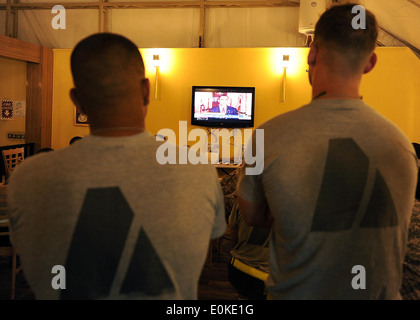 Two U.S. Army soldiers watch President Obama talk about the details of the death of 9/11 mastermind Osama bin Laden on the tele
