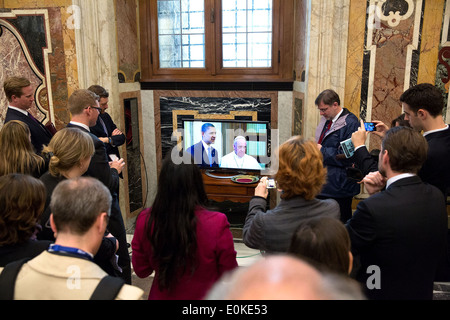 Members of the press watch on closed-circuit television as President Barack Obama meets with Pope Francis at the Vatican March 27, 2014 in Vatican City. Stock Photo
