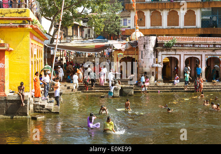 People bathe in the holy water of the Godavari River at Ram Kund (Ganga Ghat). Stock Photo