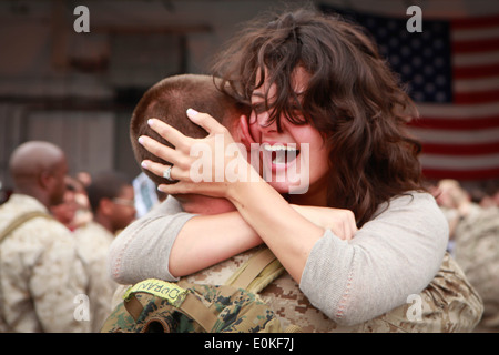 Cpl. Colton Duran, an aircraft mechanic for the EA-6B Prowler with Marine Tactical Electronic Warfare Squadron 2, hugs his wife Stock Photo