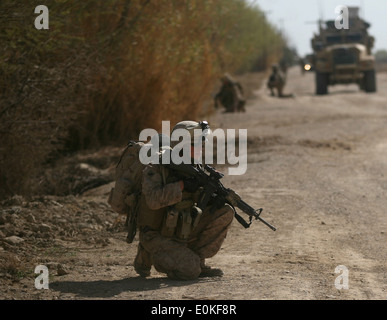 Seaman Casey McLaughlin, a corpsman with India Company, 3rd Battalion, 6th Marine Regiment, provides security during a patrol i Stock Photo