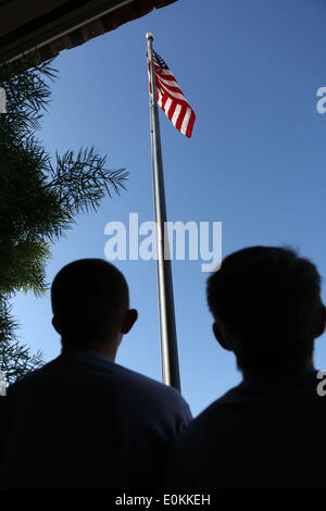 Los Alamitos, CA, USA. 14th May, 2014. Children say the pledge of allegiance at St Hedwig Catholic school in Los Alamitos, California. Julian Cesneros, a soldier with the 349th Quartermaster Company in the 40th Infantry Division of the California National Guard, surprised his daughter at school that morning. Julian had completed two back to back deployments and had been away from his family for 11 months in Afghanistan this time around. © Krista Kennell/ZUMAPRESS.com/Alamy Live News Stock Photo