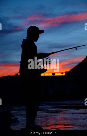 Boy fishing, Ohau Canal, Mackenzie Country, South Canterbury, South Island, New Zealand Stock Photo