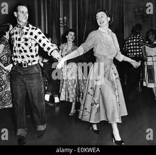 Queen Elizabeth II and Prince Philip line dancing Stock Photo