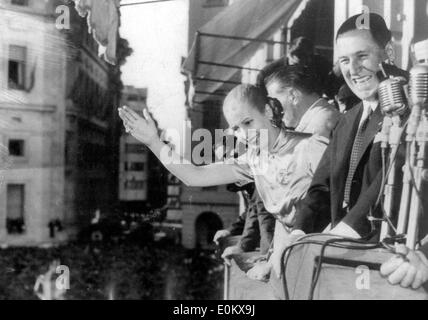 President Juan Peron and his wife Evita wave from a balcony Stock Photo