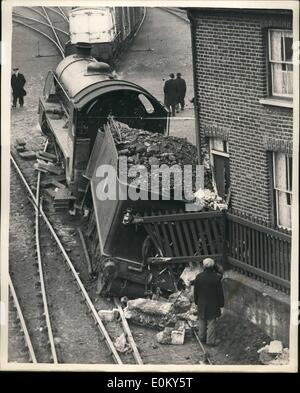 Nov. 11, 1952 - Shunting Engine And Tender Crash Into Cottage At Brentford, Middlesex... While shunting trucks at Brentford, Middlesex, goods yard, the tender of the engine became derailed and leaned against the front door of a cottage.. Heavy lifting gear had to be called to put the engine back on the rails. Stock Photo