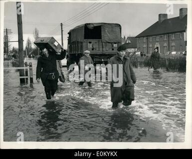 Feb. 02, 1953 - Flood scenes at Canvey Island. Victims carry their goods through the Main Street. Photo shows flood victims on carrying their goods and chattela through the flooded main street at Canvay Island today. Stock Photo