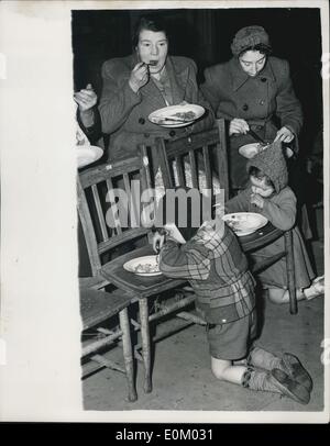 Feb. 02, 1953 - Flood Victims Receive Assistance At The Canning Town Public Hall: Hundreds of flood victims from parts of Canning Town - spent last night at the Canning Town Public Hall. They expect to stay there until, their homes are freed from the waters. Photo shows Flood victims at the Canning Town Public Hall this afternoon a meal. Stock Photo