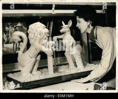 Mar. 03, 1953 - Rival Cricketers - In Butter, preview of ideal home exhibition; This striking sculpture in Australian butter, showing the British lion and the Australian kangaroo with cricket pads and bat, was made by Mr. Hail of Hamstead, a teacher at Harrow School of Art. the work was done in a cold room. Looking at the sculpture is Miss Marigold Sherwood, of South Kensington, at today's preview of the Ideal Home Exhibition which opens tomorrow at Olympia. Stock Photo