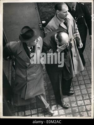 Apr. 04, 1953 - John Christie again appears at the West London Magistrates' Court ...John Reginald Halliday Christie, 54, year old haulage clerk appeared at the West London Magistrate's Court again this morning after being remanded for a week on a charge of murdering his wife, Ethel Christie.. Photo shows John Christie covers his face with his hands as he arrives at the Court this morning. Stock Photo