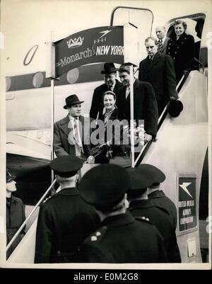 Mar. 20, 1953 - Sir Laurence Olivier brings his wife Rome, Vivien Leigh arrives at London Airport; Vivien Leigh accompanied by her husband Sir Laurence Olivier arrived at London Airport this afternoon at the end of their flight from Hollywood - via New York. Great difficulty was experience in getting Miss Leigh into the aircraft at New York owing to her dread of flying. She is suffering from a nervous breakdown. Photo Shows Officials and police look on as Vivien Leigh, accompanied by her husband Sir Laurence Olivier walk down the steps of the aircraft at London Airport this afternoon. Stock Photo