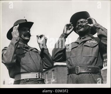 May 05, 1953 - West African R.S.M.'s check their mustaches colonial coronation contingent at woolwich: Members of the colonial coronation contingent, which will number 500 and he representative of all dependent territories - who will take part in the coronation return processors, were to be seen this morning at the royal artillery depot at woolwich. Photo shows (L to R) R.,S.M. Reginald caldicott, of the west African contingent, from Nigeria - and R.S.M. ana maiduguri, of the same detachment - seen hinlg mustaches at woolwich today. Stock Photo