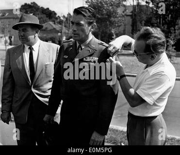 Actor Gregory Peck getting his costume adjusted on set of 'Man at Night' Stock Photo