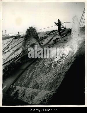 Aug. 26, 1953 - Raising the ''Kronprins Federik''.: Efforts to raise he sunken Denish liner, ''Kronprins Federeik'', which capaized and sank after being swept bu fire at Harwich in April, are being made today. Salvage men have been working this morning to left her. Photo shows water being pumped from the ship early this morning, as the cable were checked before the raising operation. Stock Photo