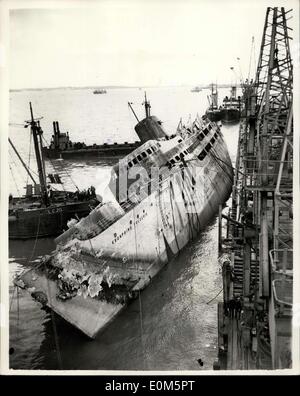 Aug. 26, 1953 - Raising the ''Kronprins Frederick'': Efforts to raise the sunken Danish liner, ''Kronprins Frederick'', which capaised and sunk after being swept by fire at Harwich, in April, are being made today. Salvage men have began this morning to lift her. Picture Shows: Preparations for the lift began at 6.30 a.m. this morning- and this was the scene at 11.30 a.m. showing the ship at a 30 degrees list. Stock Photo