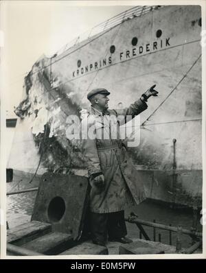 Aug. 26, 1953 - Raising the ''Kronprins Frederik'' Efforts to raise the sunken Danish liner ''Kronprine Frederik'' which capsized and sank after being swept by fire at Harwirl, in April, are being made today. Salvage men have been working on the ship for months, and work began this mornin to lift her. Photo shows Capt. N.H. Lauridsen of Esbjerg, Denmark-the captain of the ship when she caught fire-seen looking over the ''Kronprins Frederik'' during today's lifting operations at Harwich. Stock Photo