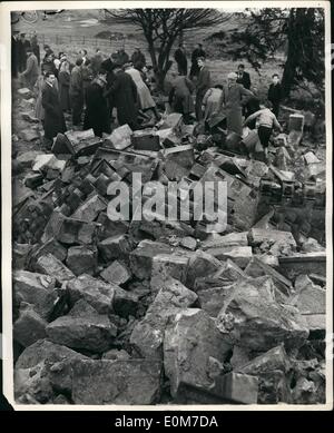 Jan. 01, 1954 - Gelignite Used To Destroy Ancient Steeple In Hamilton - Scotland: About 1,000 people, including many schoolchildren watched the detraction of the Old Tollbooth Steeple, in Muir Street, Hamilton,, Scotland, recently - with the aid of gelignite charges, The Steeple bell and tolled out the hours for 312 years but the steeple foundation were eaten away and it maned a nearby housing scheme. Photo Shows The explosion are over and onlookers scramble among the hundreds of bricks and stones which formed the steeple - at Hamilton. Stock Photo