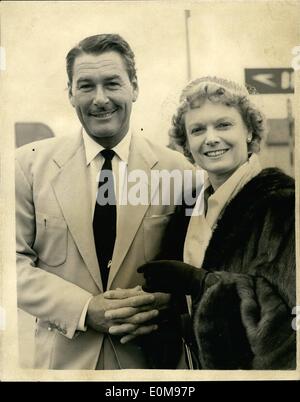 Apr. 04, 1954 - Errol Flynn Arrives.: Hollywood film star Errol Flynn, who is to star with Anna Neagle in her next film ''Lilacs in the Spring'', arrived at London Airport today. Photo shows Errol Flynn, seen at London Airport today, with Anna Neagle, who, with Herbert Wilcox met him at the airport. Stock Photo