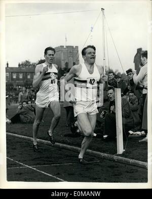 May 05, 1954 - Roger Bannister does it. Runs mile in under four minutes.: Britain' Roger Bannister has done it. Last night he ran the fabulous four- minute mile, a feet which the world's athletes have been trying to achieve for years. His time was three minutes 59.4 seconds. As he passed the post at Oxford's Iffley- road track he was swept up in a mass of cheering, shouting spectators. Photo shows the world record mile lap by lap. Chris Chataway in the lead after three laps (3 mins. .05 sec) with Bannister behind tensed for the record. Stock Photo