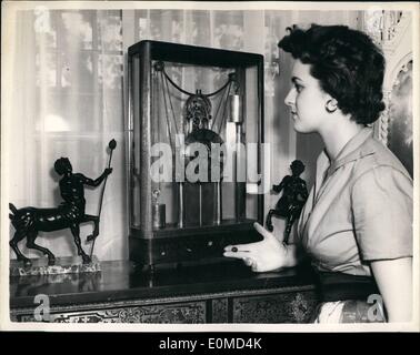 Sep. 09, 1954 - Autumn antique Dealer's Fair at Chelsea Town Hall. Needlework Chess Set. Press preview was held this afternoon at Chelsea Town Hall of the Autumn Antique Dealer's Fair. Keystone Photo Shows: Jacqueline Bromley admires a early American 19th century - 8 day skeleton mantel clock with thermometer below the dial. The clock is wound by cord underneath base. Stock Photo