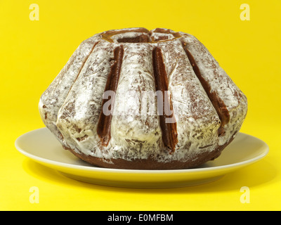 Traditional Easter Cake with glazing over yellow background Stock Photo