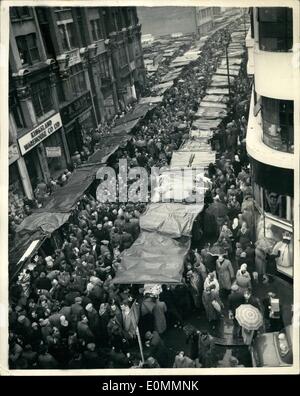 Dec. 12, 1955 - GREAT CROWDS DEFY THE RAIN FOR THEIR CHRISTMAS SHOPPING IN PETTICOAT LANE. With the shopping days to Christmas growing fewer great crowds flocked to Petticoat Lane, London's Sunday morning open-air market, despite the rain this morning. PHOTO SHOWS: The scene in Middlesex Street this morning as crowds of shoppers searched for Christmas bargaining despite the rain. Almost every conceivable commodity is on sale in this market. Stock Photo