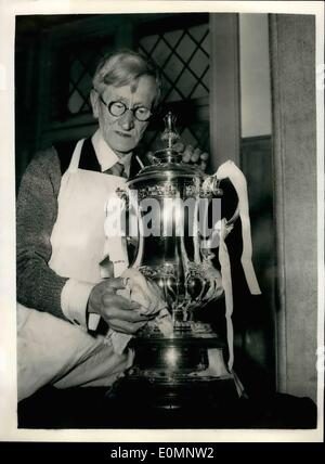 Apr. 04, 1956 - Sports Trophies On Show In London: The National Association of Boys' Clubs are holding an exhibition at the Cafe Anglais, at which some of Britain's greatest sports trophies are on show. Photo shows 75-year old Fred Packham, of Birmingham, a foreman plater and polisher, who for the past three years has been responsible for the polishing of the F.A. Cup in readiness for the presentation at Wembley - seen at the Cafe Anglais today giving the F.A. Cup a polish up in readiness for the exhibition. Stock Photo