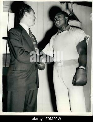 May 05, 1956 - Archie Moore meets Jack (kid) Berg at his training quarters.: Archie Moore, the world light-heavyweight champion, who is now in training at the start and Garter Hotel, Windsor, as visited by ex-lightweight champion, Jack (kid) Berg at his camp today. Photo Shows Archie Moore shakes hands with Jack (kid) berg at his training quarters at Windsor today. Stock Photo