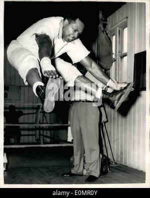 May 05, 1956 - Archie Moore goes into training Windsor: Archie Moore the world light-heavyweight champion, now in training for his fight with Yolande Pompey in June. He has taken up quarter at the  and Carter Hotel, Windsor. Photo shows Archie leaps into the air and touches his toes as part of his work-out routine at his training camp today. Stock Photo