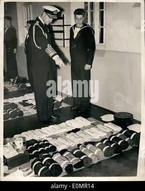 May 05, 1956 - Duke of Edinburgh visits Naval training base. inspects kit issued to a recruit.: H.R.H. the Duke of Edinburgh wearing the uniform of an Admiral of the Fleet yesterday visited H.M.S. Ganges the Royal Naval Shore Training Establishment at Shotley. Photo shows the Duke of Edinburgh seen as he inspects the kit issued to one of the recruits at H.M.S. Ganges. Stock Photo