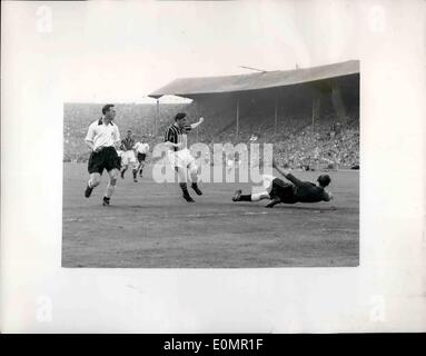 May 05, 1956 - Manchester city win the F.A. cup. beat Birmingham by three goals to one. Photo shows G. Merrick, the Birmingham goalkeeper - makes a vain attempt to stop Manchester City's third goal - scored by B. Johnston (centre), the Manchester City outside-right, during the F.A. Cup Final at Wembley today. Stock Photo