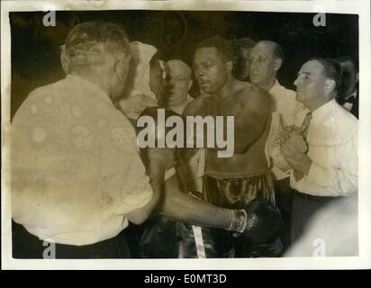 Jun. 06, 1956 - Archie Moore retails his light - heavy weight title. Beats Yolande Pompey in tenth round. Archie Moore the light heavy weight champion on the world - last night retained his title, when he beat Trinidad's Yola De Pompey - the referee stopping the contest in the tenth round - at Harringay. photo shows Archie Moore Inspects the injuries which he inflicted on Yolande Pompey after his victory at Harringay last night. Stock Photo