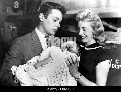 Actor Tony Curtis and his wife Janet Leigh holding their daughter Kelly Lee Curtis Stock Photo
