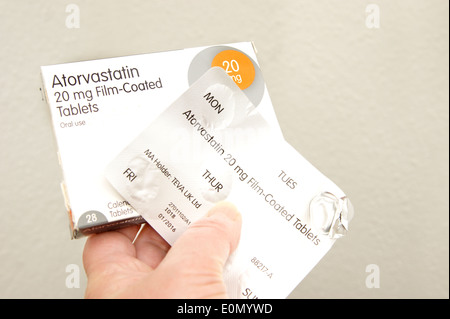 Woman holding a pack of Atorvastatin tablets (statins) Stock Photo