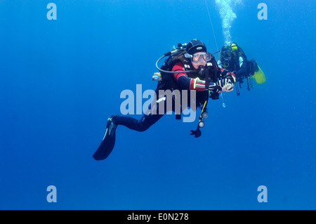 Two scuba divers doing safety stop on line Stock Photo