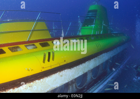 Yellow submarine with scuba diver swimming next to a porthole, Tenerife ...