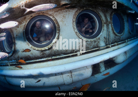 Tourists on Submarine Safaris' yellow sub underwater looking out of portholes, Tenerife Stock Photo