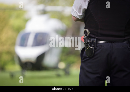 Met police and MD902 Explorer helicopter from the Kent, Surrey & Sussex Air Ambulance Trust on the ground in Ruskin Park after emergency flight to Kings College Hospital in south London. Stock Photo