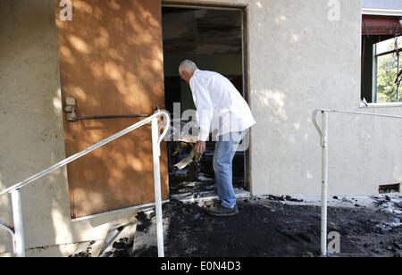 San Diego, California, USA. 16th May, 2014. May 16, 2014--Escondido, CA--SENIOR PASTER Floyd Freeman examines the ruins of the Calvery Assembly of God Church in Escondido that burned in the early morning hours of May 16. While the cause of the fire is unknown, witnesses say that a person was around the building shortly before it burned. Not far away, a 3000-acre fire in San Marcos continued to burn as fire fighters has obtained about 10 percent containment. The fire burned at least three structures near Cal State San Marcos. Stock Photo