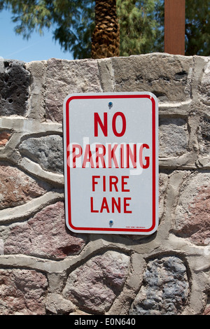 No Parking Fire Lane sign on a natural stonewall Stock Photo