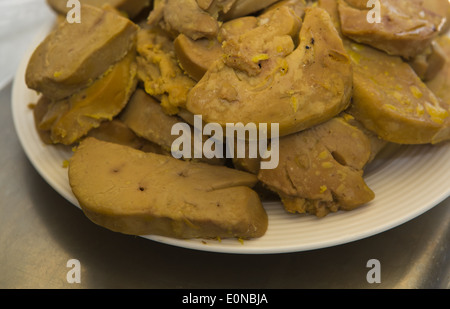 Pieces of raw duck foie gras on a porcelain plate Stock Photo