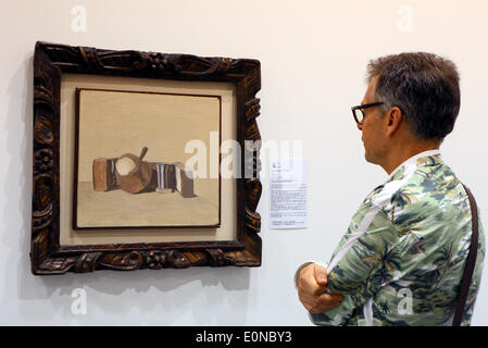 Hong Kong, China. 16th May, 2014. A visitor looks at a still life painting by Italian artist Giorgio Morandi during the second Art Basel in Hong Kong, south China, May 16, 2014. A total of 245 premier galleries from 39 countries and regions took part in the world renowned art show this year. © Li Peng/Xinhua/Alamy Live News Stock Photo