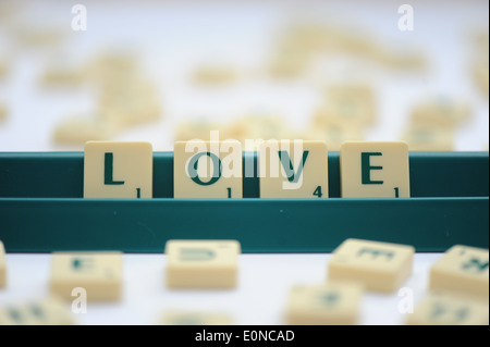 Scrabble tiles reading out the words love Stock Photo