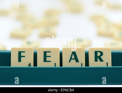 Scrabble tiles reading out the words fear Stock Photo