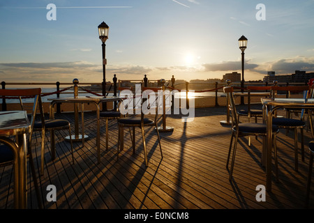 Seating outside Worthing Pier's South Pavilion in the evening light Stock Photo