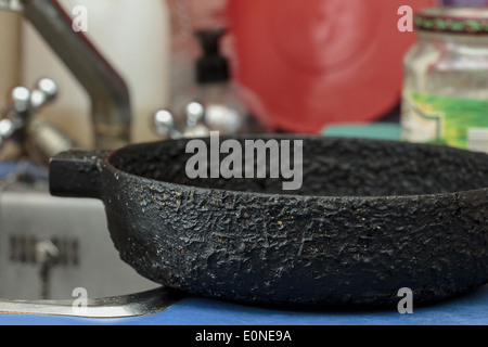 Old cast iron black skillet in kitchen Stock Photo