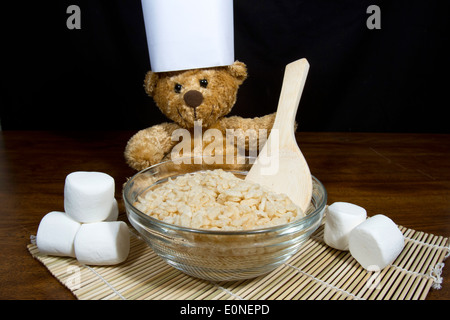 Cute teddy bear chef making puffed rice cereal cookie treats Stock Photo