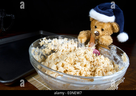 Cute Christmas bear making puffed rice cereal cookie treats Stock Photo